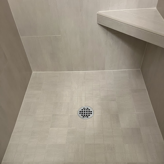 Bright, clean shower grout after professional cleaning