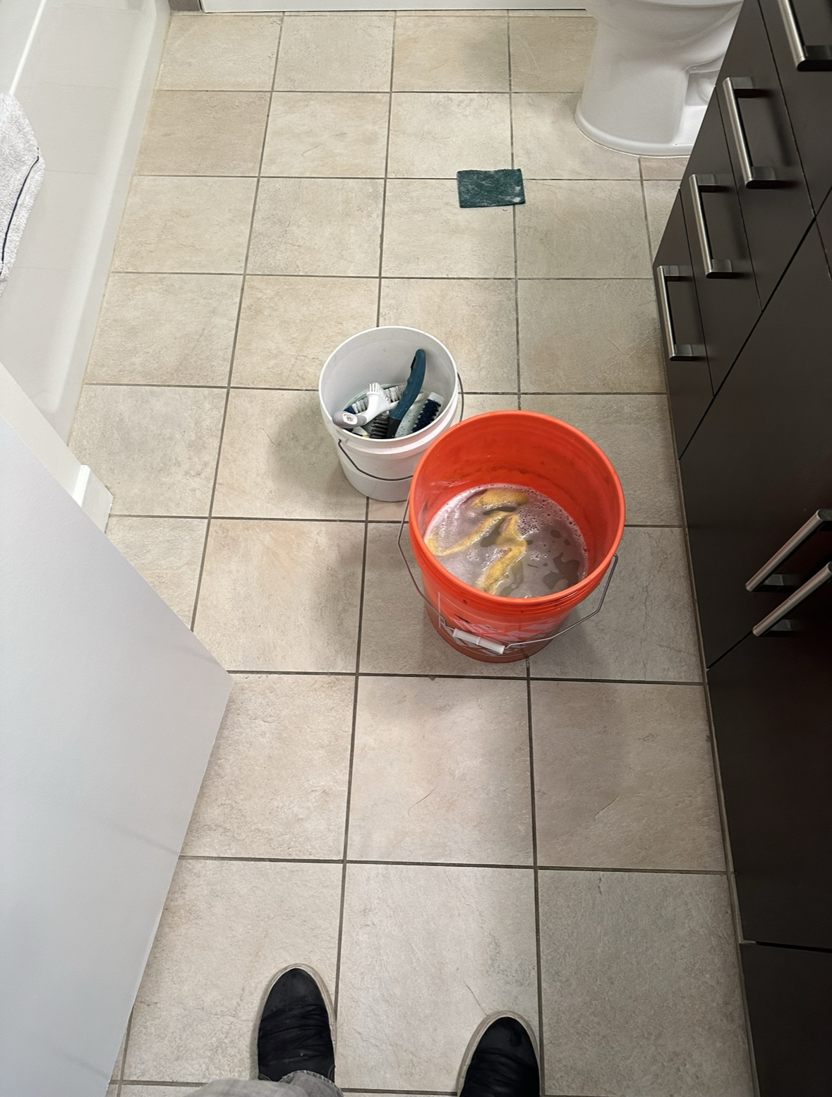 Bathroom floor grout being professionally cleaned